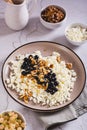 Homemade cottage cheese with fresh blackcurrants and walnuts on a plate vertical view Royalty Free Stock Photo