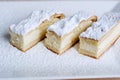 cottage cheese casserole from cottage cheese for Easter sprinkled with powdered sugar on a plate three pieces are cut