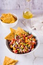 Homemade cowboy caviar traditional mexican vegetable salad and nachos in a bowl. Vertical view Royalty Free Stock Photo