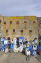 Homemade Crab and Lobster Pots out of old Blue Drums stacked untidily against the Harbour Wall at Slade. Royalty Free Stock Photo