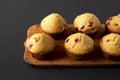 Homemade Cranberry Muffins with Orange Zest on a rustic wooden board on a black background, side view. Copy space Royalty Free Stock Photo