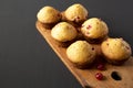 Homemade Cranberry Muffins with Orange Zest on a rustic wooden board on a black surface, side view. Copy space Royalty Free Stock Photo