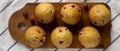 Homemade Cranberry Muffins with Orange Zest on a rustic wooden board on cloth, top view. Flat lay, overhead, from above Royalty Free Stock Photo