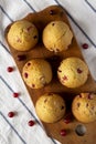 Homemade Cranberry Muffins with Orange Zest on a rustic wooden board on cloth, top view. Flat lay, overhead, from above Royalty Free Stock Photo