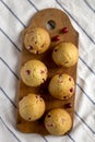 Homemade Cranberry Muffins with Orange Zest on a rustic wooden board on cloth, top view. Flat lay, overhead, from above Royalty Free Stock Photo