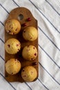 Homemade Cranberry Muffins with Orange Zest on a rustic wooden board on cloth, top view. Flat lay, overhead, from above. Space for Royalty Free Stock Photo