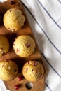 Homemade Cranberry Muffins with Orange Zest on a rustic wooden board on cloth, view from above. Flat lay, overhead, top view. Copy Royalty Free Stock Photo
