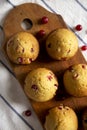 Homemade Cranberry Muffins with Orange Zest on a rustic wooden board on cloth, view from above. Flat lay, overhead, top view Royalty Free Stock Photo