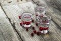 Homemade cranberry vodka, wooden background Royalty Free Stock Photo