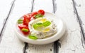 Homemade cream cheese with cherry tomatoes, basil and olive oil close up