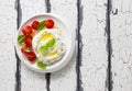 Homemade cream cheese labneh wiht cherry tomatoes, basil and olive oil