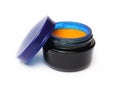 Homemade cream with sea buckthorn oil in blue glass can