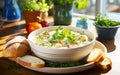 Homemade Creamy clam chowder, brimming with plump clams hearty potatoes and aromatic herbs soup in white bowl on table near window Royalty Free Stock Photo