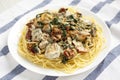 Homemade Creamy Tuscan Chicken with Pasta on a white plate on cloth, side view Royalty Free Stock Photo