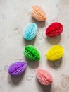 Homemade creative paper Easter eggs on a light background, top view. Easter decorations, creativity concept