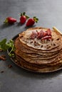 Crepes with almonds, strawberry and castor sugarsugar