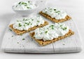 Homemade Crispbread toast with Cottage Cheese and parsley on white wooden board. Royalty Free Stock Photo