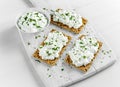 Homemade Crispbread toast with Cottage Cheese and parsley on white wooden board. Royalty Free Stock Photo