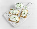 Homemade Crispbread toast with Cottage Cheese and parsley on white wooden board. Royalty Free Stock Photo