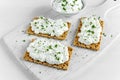 Homemade Crispbread toast with Cottage Cheese and parsley on white wooden board. Royalty Free Stock Photo