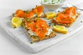 Homemade Crispbread toast with Smoked Salmon, Melted Cheese and cress salad. on white wooden board Royalty Free Stock Photo