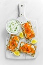 Homemade Crispbread toast with Smoked Salmon, Melted Cheese and cress salad. on white wooden board background. Royalty Free Stock Photo