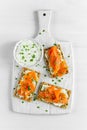 Homemade Crispbread toast with Smoked Salmon, Melted Cheese and cress salad. on white wooden board background. Royalty Free Stock Photo