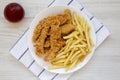 Homemade Crispy Chicken Tenders and French Fries on a white wooden background, top view. Flat  lay, overhead, from above Royalty Free Stock Photo