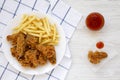 Homemade Crispy Chicken wings and French Fries with sour-sweet sauce on a white wooden background, top view. From above, overhead Royalty Free Stock Photo