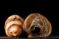 Homemade croissant cut in half on a black background Royalty Free Stock Photo