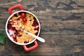 Homemade crumble with cherries and nuts on a wooden background. View from above.