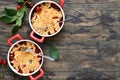 Homemade crumble with chnuts erries and on a wooden background.