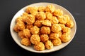 Homemade Crumbly Biscuits with Parmigiano Reggiano on a Plate on a black background, side view. Close-up