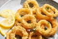 Homemade crunchy fried onion rings and lemon slices Royalty Free Stock Photo