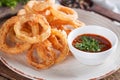 Crunchy fried onion rings with tomato sauce