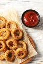 Homemade crunchy fried onion rings with tomato sauce on wooden table Royalty Free Stock Photo