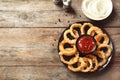 Homemade crunchy fried onion rings with tomato sauce on wooden table, top view Royalty Free Stock Photo