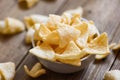 Homemade crunchy prawn crackers or shrimp crisp rice - prawn crackers chips on white bowl and wooden table background