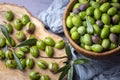 Homemade crushing olive making. Fresh green olives are breaking one by one. Crushing olives with stone. Preparing pickled olives