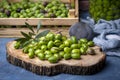 Fresh green olives are breaking one by one. Crushing olives with stone. Preparing pickled olives