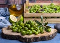 Homemade crushing olive making. Fresh green olives are breaking one by one. Crushing olives with stone.