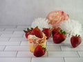 Homemade cupcake with sprinkles and fresh strawberries on the floor Royalty Free Stock Photo