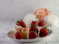 Homemade cupcake with sprinkles and fresh strawberries on a white plate Royalty Free Stock Photo