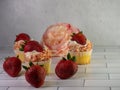 Homemade cupcakes with sprinkles and fresh strawberries on the floor Royalty Free Stock Photo