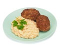Homemade cutlets with wheat porridge on a plate on white background.