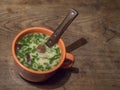 Homemade Czech traditional delicious soup Kulajda with mushroom, eggs and fresh dill in orange cup and spoon close-up on Royalty Free Stock Photo