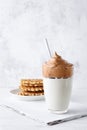 Dalgona coffee with waffles. Korean coffee cold drink with whipped instant coffee and milk