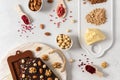 Homemade dark chocolate bars and pralines in molds with dried berries and nuts on white background. Chocolate made of organic Royalty Free Stock Photo