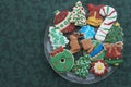 Homemade Decorated Cutout Christmas Cookies On Clear Plate,Green Tablecloth