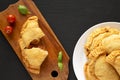 Homemade Deep Fried Italian Panzerotti Calzone with sauce on a black background, top view. Flat lay, overhead, from above. Copy Royalty Free Stock Photo